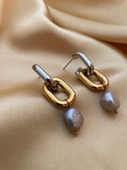 Two-tone silver and gold interlocked link hoop earrings featuring lustrous grey baroque pearl