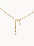 Gold necklace with two 4 mm white baroque freshwater pearl pendants suspended at contrasting lengths