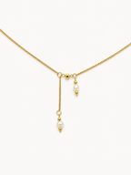Gold necklace with two 4 mm white baroque freshwater pearl pendants suspended at contrasting lengths