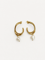 Pair of sculptural gold hoop earrings with 10 mm white baroque freshwater pearl drops