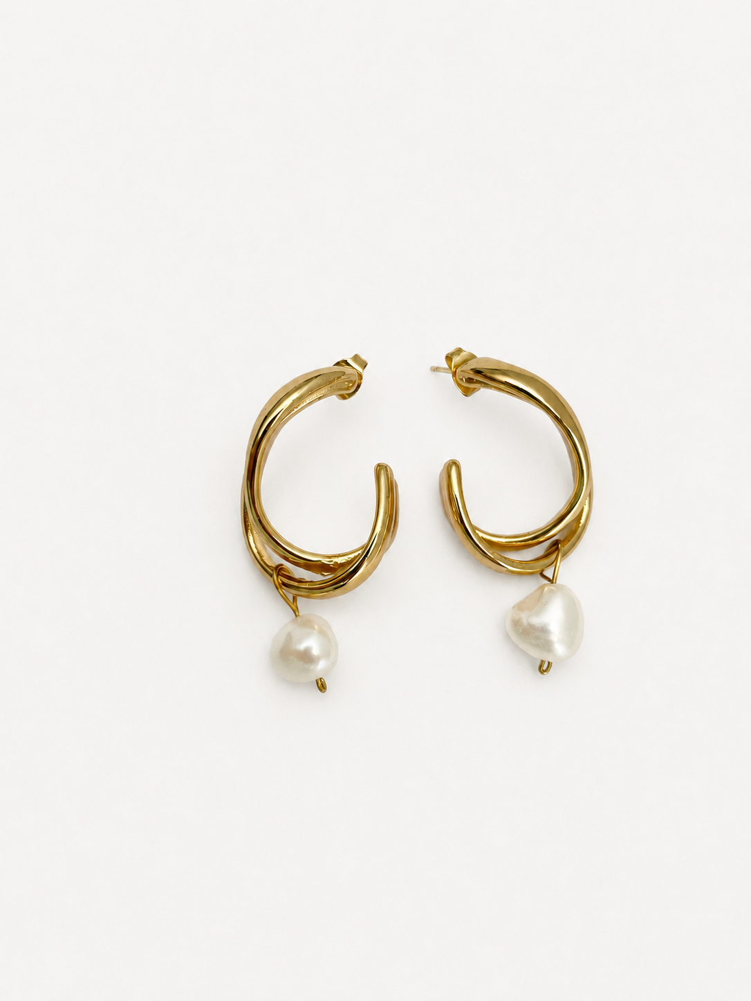 Pair of sculptural gold hoop earrings with 10 mm white baroque freshwater pearl drops