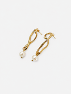 Back view of gold knot drop earrings with posts and white baroque freshwater pearl pendants