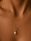 Close-up of a gold lariat Y-necklace with a 10 mm white baroque freshwater pearl and toggle detail worn on the neck