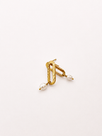 Angled pair of textured gold stud earrings with organic white baroque freshwater pearl drops.