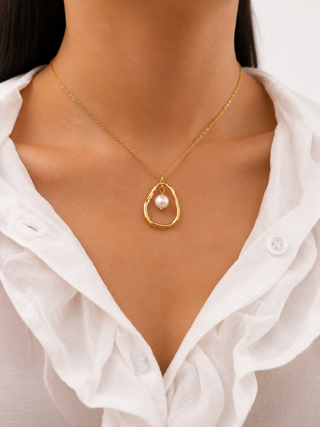 Front view of a gold molten pendant necklace with a 10 mm white baroque freshwater pearl.