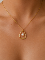 Close-up of a gold molten pendant necklace with a 10 mm white baroque freshwater pearl worn on the neck