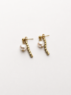 Pair of gold Siren drop earrings with 10 mm white baroque freshwater pearls and crystal drop accents.