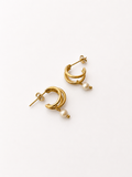 Pair of small gold triple-hoop earrings with 4 mm white baroque freshwater pearl drops.