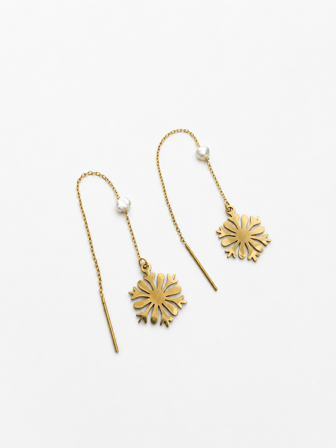 Pair of gold snowflake drop earrings with 4 mm white baroque freshwater pearls.