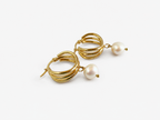 Pair of sculptural gold triple-hoop earrings with 10 mm white baroque freshwater pearl drops