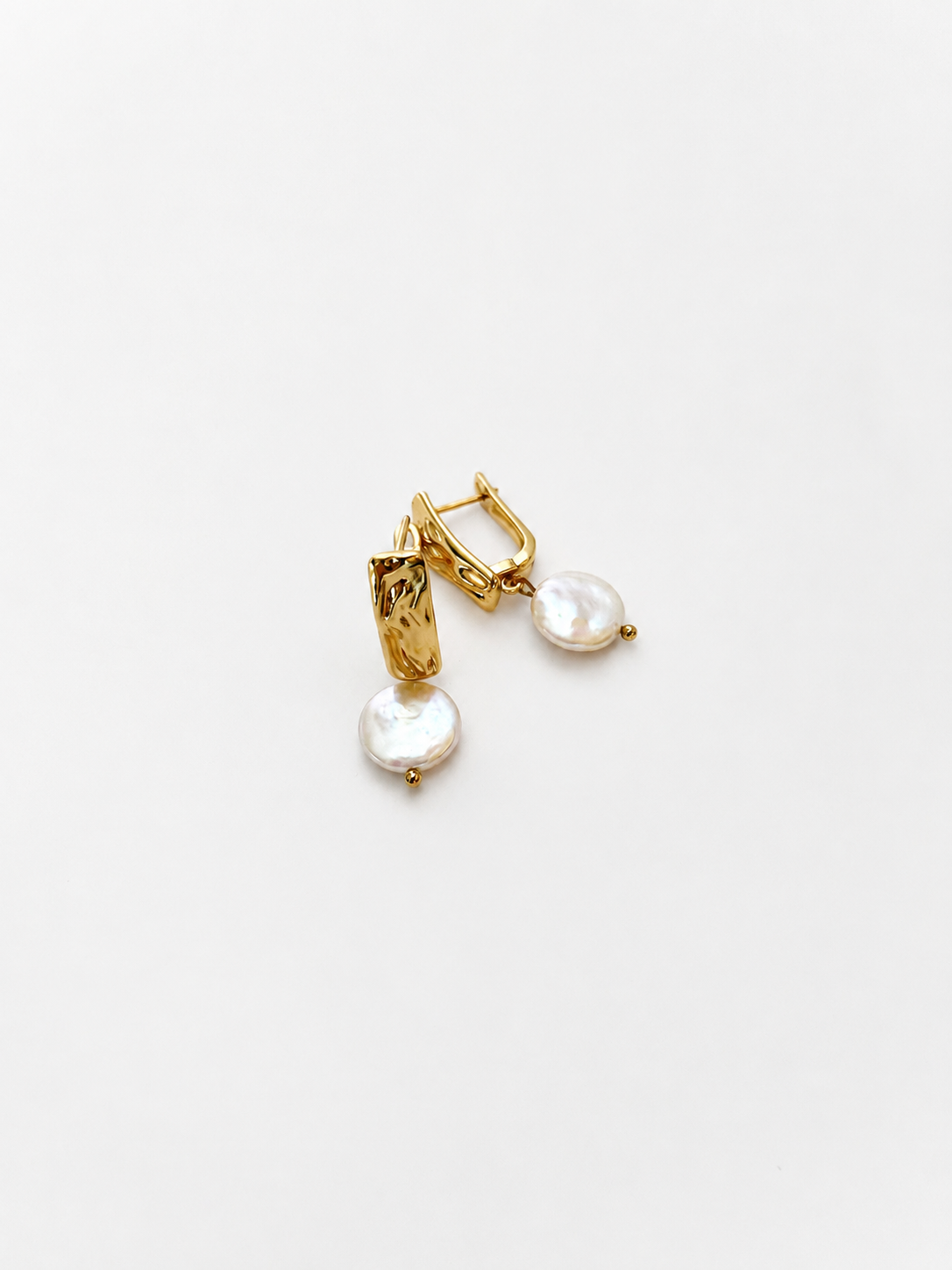 Pair of textured gold rectangle drop earrings with 10 mm white freshwater coin pearls.