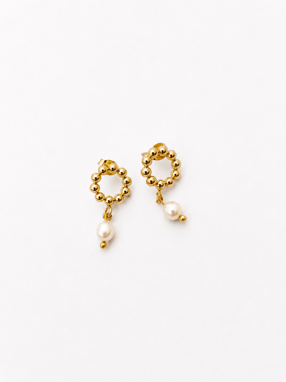 Pair of beaded gold circle stud earrings with white freshwater pearl drops