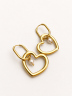 Pair of gold interlinked heart drop earrings with 6 mm oval white freshwater pearls