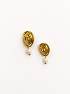 Pair of sculptural gold spiral stud earrings with 6 mm oval white freshwater pearl drops