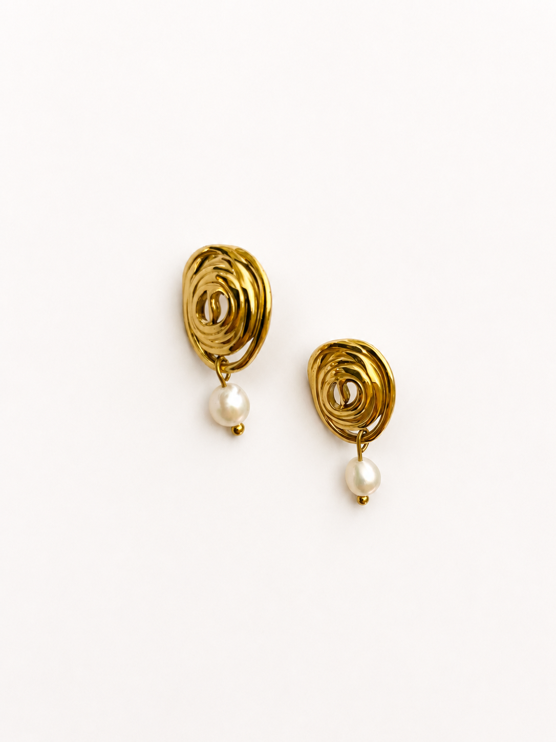 Pair of sculptural gold spiral stud earrings with 6 mm oval white freshwater pearl drops