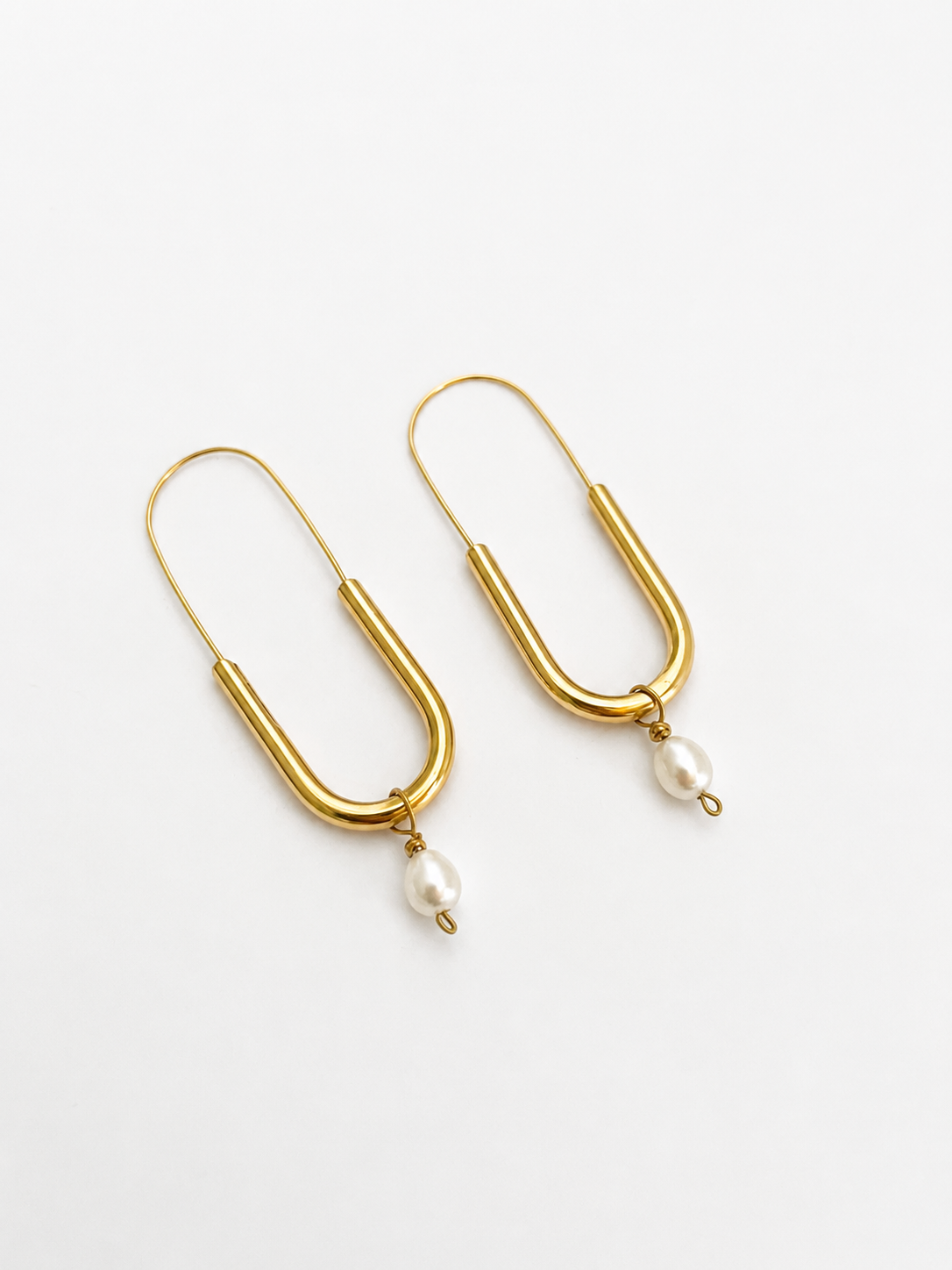 Pair of gold paperclip drop earrings with 5 mm oval white freshwater pearl pendants