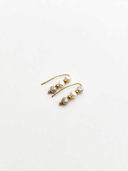 Pair of gold ear climber earrings with 4 mm white and grey baroque freshwater pearls.