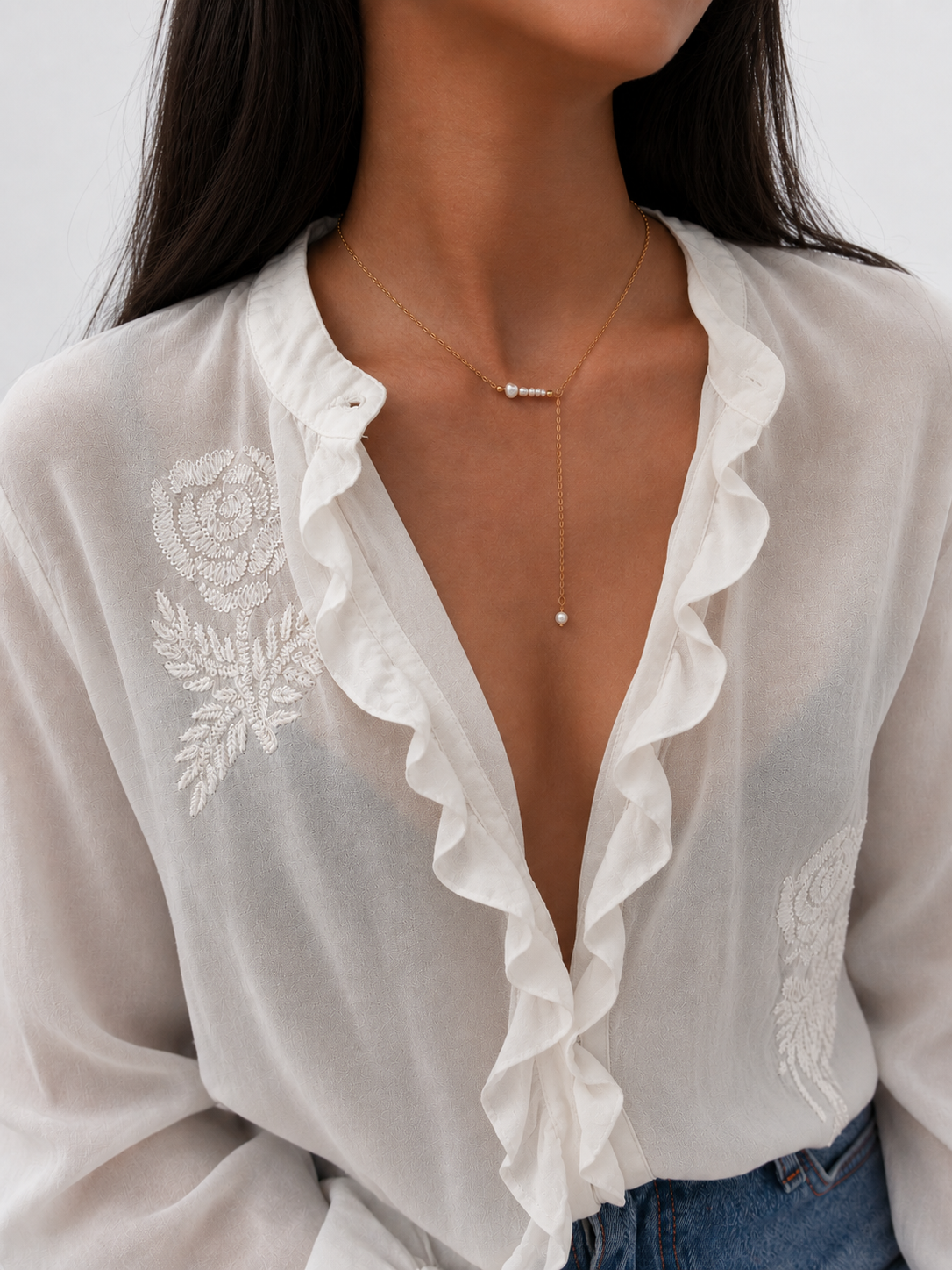 Front view of a gold Y-necklace with 6 mm, 4 mm and 2 mm white Keshi freshwater pearls.