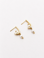 Pair of sculptural gold huggie earrings with 6 mm oval and 4 mm baroque white freshwater pearls