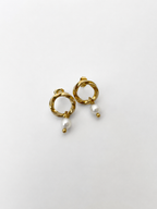 Pair of textured gold circle drop earrings with 6 mm oval white freshwater pearls
