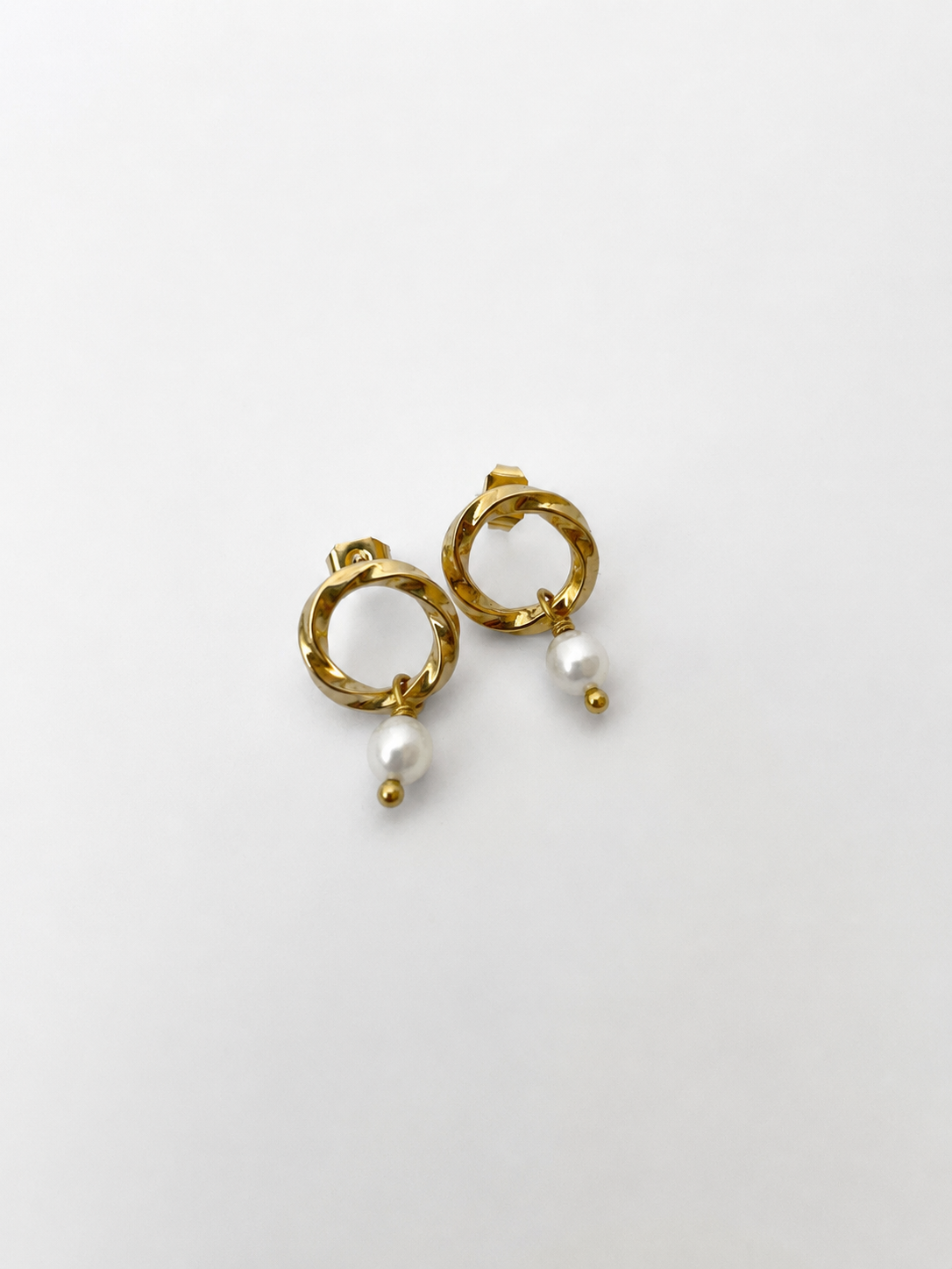 Pair of textured gold circle drop earrings with 6 mm oval white freshwater pearls