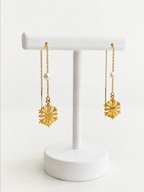 Front view of gold snowflake threader earrings with white baroque freshwater pearls.