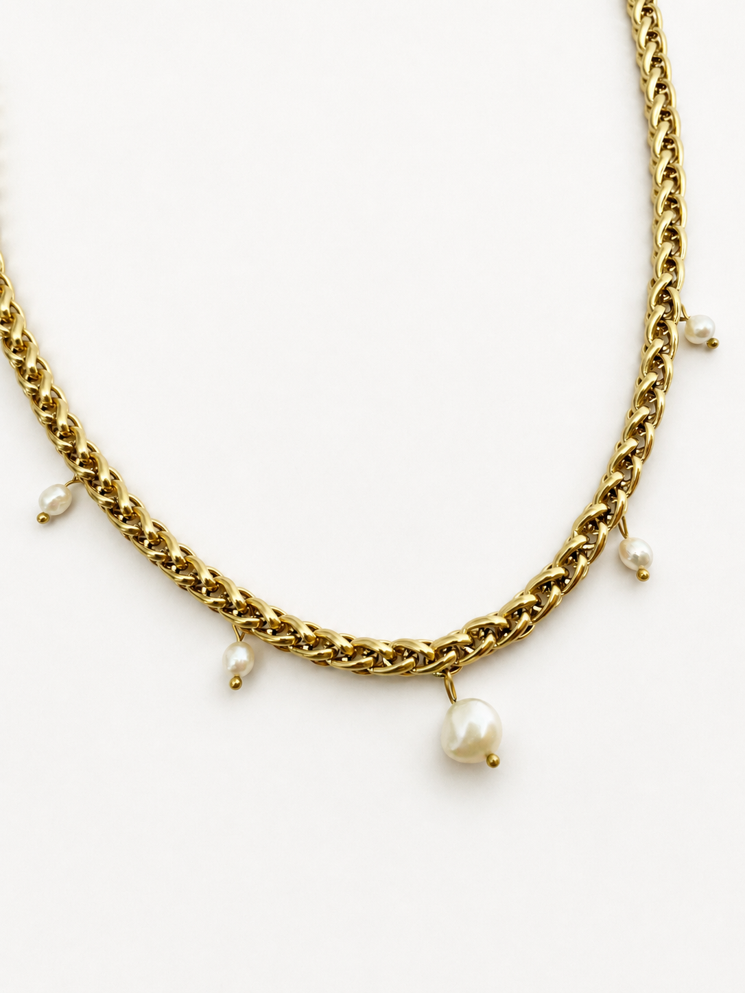 Gold statement charm necklace with a 10 mm white Baroque pearl and smaller white freshwater pearl charms